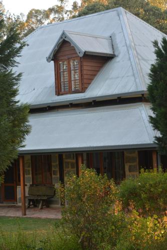 a house with a gambrel roof with a window at Thulanathi - Rest Explore Reconnect in Pokolbin