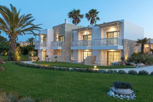 a large house with a lawn in front of it at White Pearls-Adults Only Luxury Suites in Kos Town