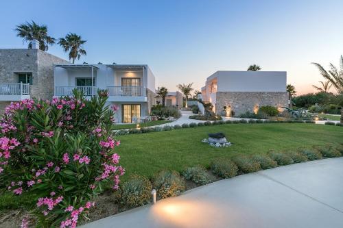 a house with a yard with pink flowers at White Pearls-Adults Only Luxury Suites in Kos Town