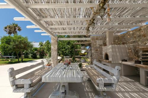 a picnic table under a pergola on a patio at White Pearls-Adults Only Luxury Suites in Kos Town