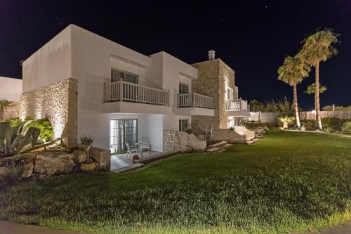 a large white house with a yard at night at White Pearls-Adults Only Luxury Suites in Kos Town