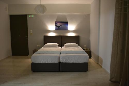 a bedroom with a bed with two pillows on it at Thegaia Studios in Rethymno Town
