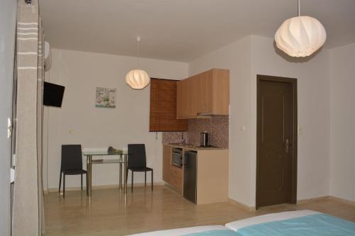 a kitchen and dining room with a table and chairs at Thegaia Studios in Rethymno Town