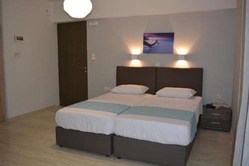 a bedroom with a large bed with two pillows at Thegaia Studios in Rethymno Town