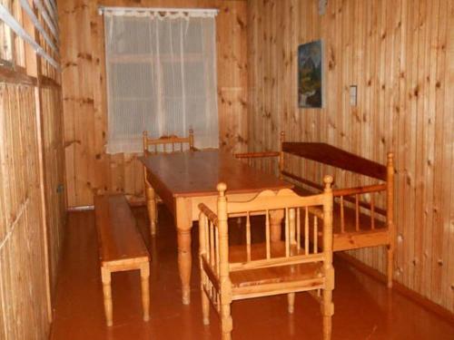 a dining room with a table and chairs in a cabin at Lagami house in Mestia