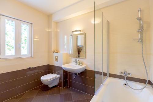 a bathroom with a toilet and a sink and a shower at Hedera Estate, Villa Hedera VII in Zaton