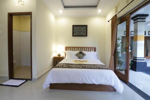 Postel nebo postele na pokoji v ubytování Pondok Mundeh Ubud