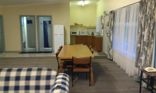a living room with a table and chairs at Avalon Motel in Mount Gambier