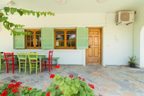 a patio with a table and chairs in a house at Athena Villas Olive Grove & Estate in Gouves
