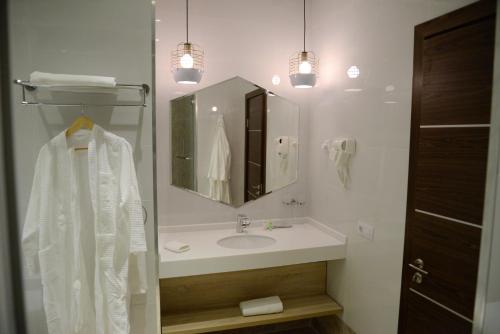 a bathroom with a sink and a mirror at GREEN Which Hotel Kokshetau in Kokshetau