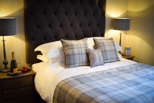 a bedroom with a large bed with a large headboard at Benoch Lomond Castle in Alexandria