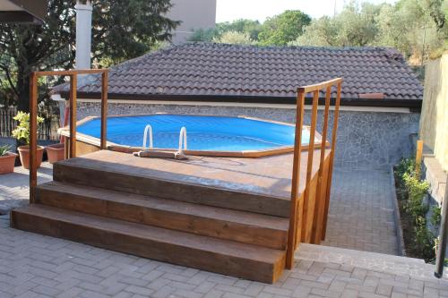 a swimming pool on a set of stairs next to a house at Casa Vacanza Etna in Linguaglossa