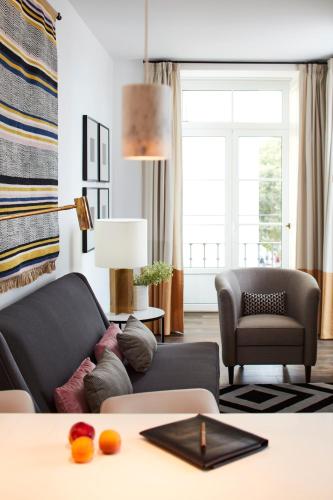 a living room with a couch and a chair at The Lumiares Hotel & Spa - Small Luxury Hotels Of The World in Lisbon