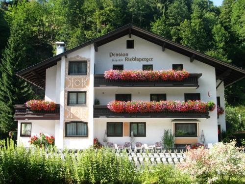 a building with flowers on the balconies at Pension Riedlsperger in Saalbach Hinterglemm