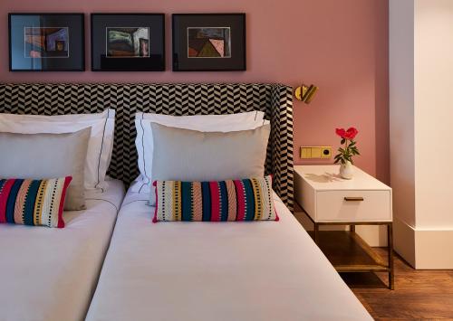 a bedroom with two white beds and a side table at The Lumiares Hotel & Spa - Small Luxury Hotels Of The World in Lisbon