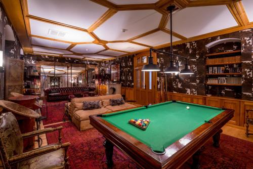 a living room with a pool table in it at Riffelalp Resort 2222m Ski-in & Ski-out in Zermatt