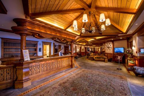 a large living room with a large wooden ceiling at Riffelalp Resort 2222m Ski-in & Ski-out in Zermatt
