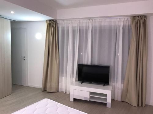 a living room with a flat screen tv sitting on a table at Holiday home Isola Rossa in Isola Rossa