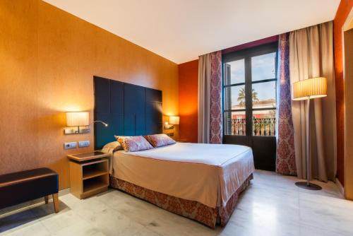 Habitación de hotel con cama y ventana en Hotel Medinaceli, en Barcelona