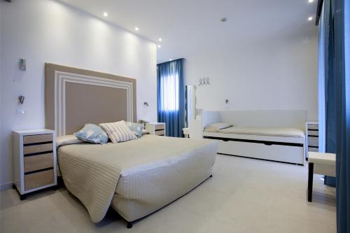 a bedroom with a bed and two bunk beds at Hotel Speranza in Lido di Jesolo