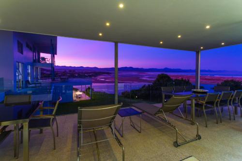 a house with a view of the ocean at night at No1 Sangaree in Plettenberg Bay
