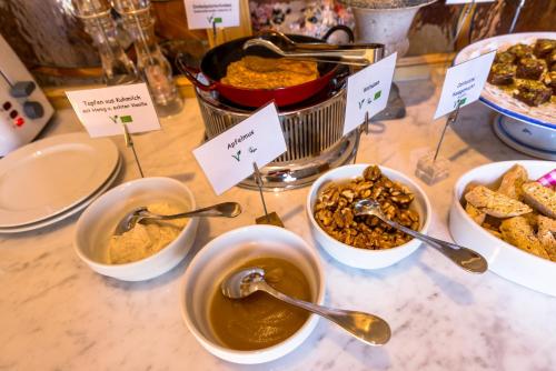 a table topped with bowls of food and spoons at Birkenhof Loipersdorf in Loipersdorf bei Fürstenfeld