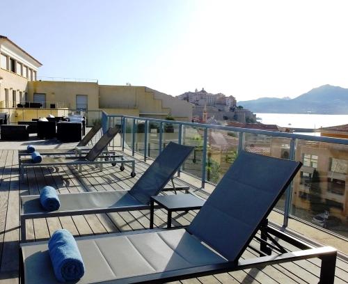 a group of chairs sitting on top of a balcony at Le Mariana in Calvi