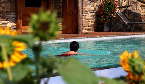 a woman swimming in a swimming pool at Apartments Pitschlmann in Fiè