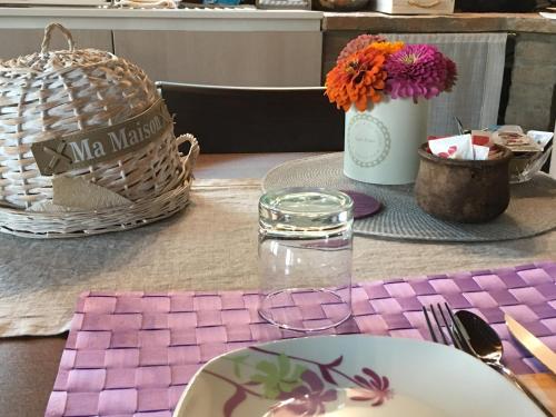 a table with plates and baskets and flowers on it at La Corte D'Emilio B&B in Vignola