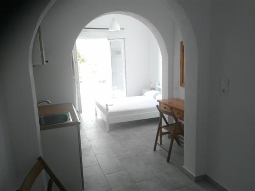 a kitchen with a sink and a table in a room at Sunset in Iraklia