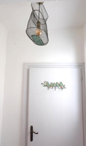a light hanging over a door with a fish sticker on it at Casa Mongolfiere Venezia in Venice