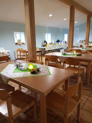 a dining room with wooden tables and chairs at Herberge-Wichernhaus-Boltenhagen in Boltenhagen