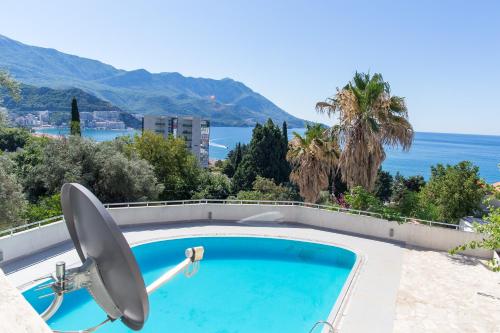 a swimming pool with a view of the ocean at The Turtles Garden in Becici