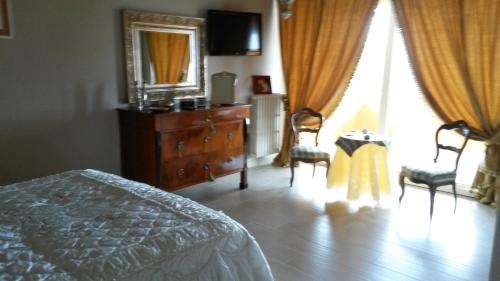 a bedroom with a bed and a dresser and a window at Villa Lucrezia in Reggello