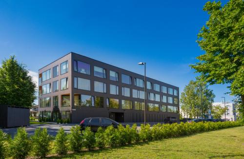 a black building with a car parked in front of it at Korter Villa 1 in Pärnu