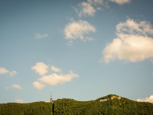 a view of a hill with clouds in the sky at Casa Moritz in Braşov