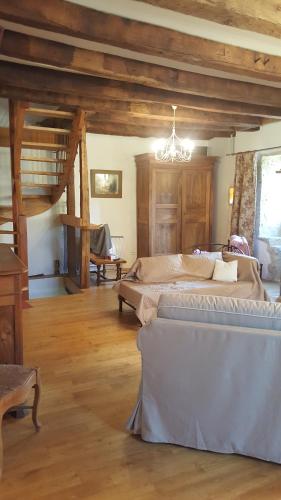 a large bedroom with two beds and a chandelier at Gite de Souilhol in Issendolus