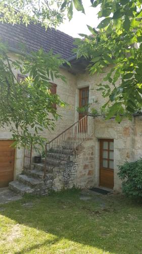 a brick house with a staircase and a door at Gite de Souilhol in Issendolus