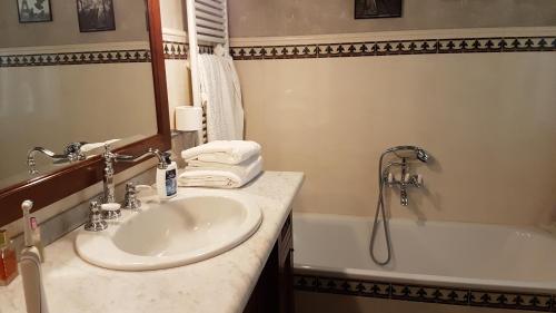 a bathroom with a sink and a bath tub at Villa Lucrezia in Reggello