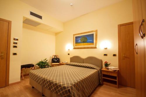 Ένα ή περισσότερα κρεβάτια σε δωμάτιο στο Hotel Villa Luca