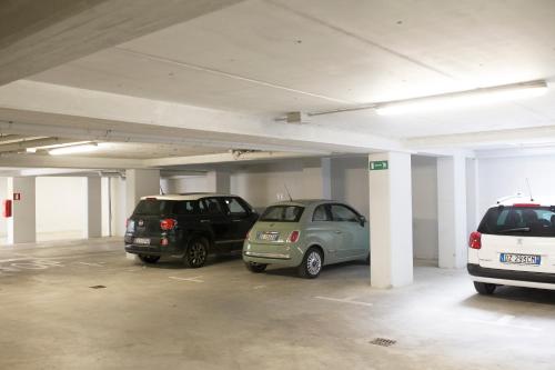 a parking garage with three cars parked in it at Residence Millecento in Cesenatico