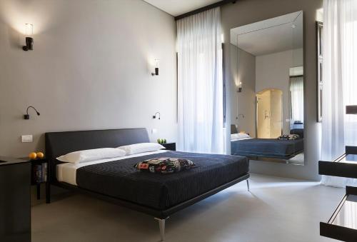 ローマにあるCasa de' Coronari Suitesのベッドルーム(ベッド1台、大きな鏡付)