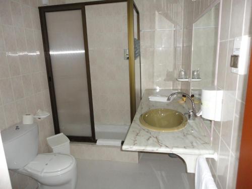 a bathroom with a sink and a toilet at Hotel Rural A Coutada - Peniche in Atouguia da Baleia