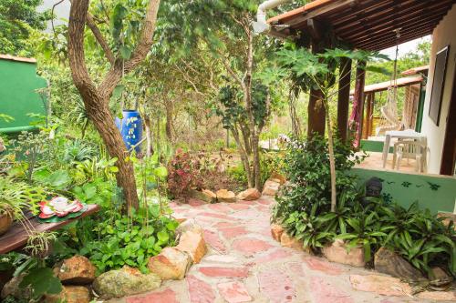 a garden with a stone walkway in front of a house at Vyzuh in Vale do Capao