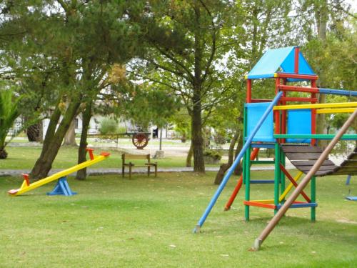 a group of playground equipment in a park at Hotel Rural A Coutada - Peniche in Atouguia da Baleia