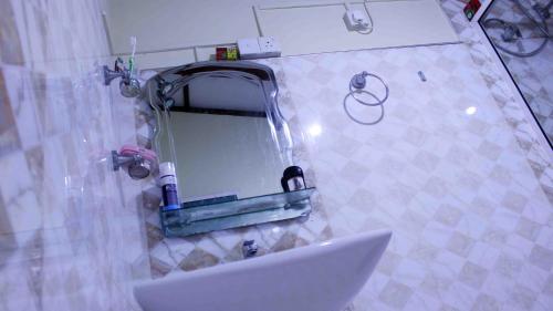 a bathroom with a sink and a mirror at Anura Home Stay in Kalutara