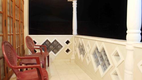 two chairs sitting on a porch with a railing at Anura Home Stay in Kalutara
