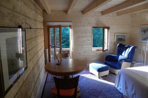 a room with a bed and a table and a chair at Spacious Swiss Alpine Chalet for Nature Lovers in Val-d'Illiez