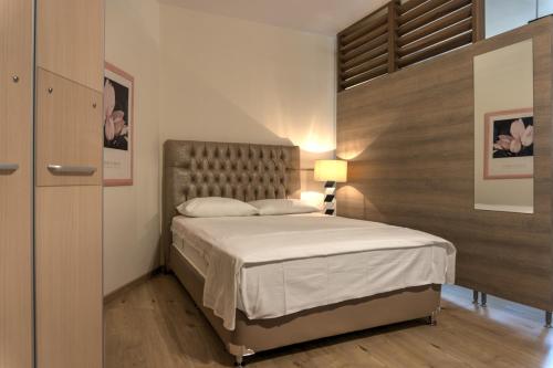 a bedroom with a large bed in a room at Kouros Studios in Kavála