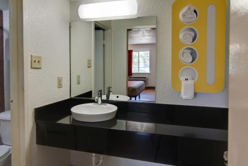a bathroom with a sink and a mirror at Motel 6-Mount Pleasant, TX in Mount Pleasant